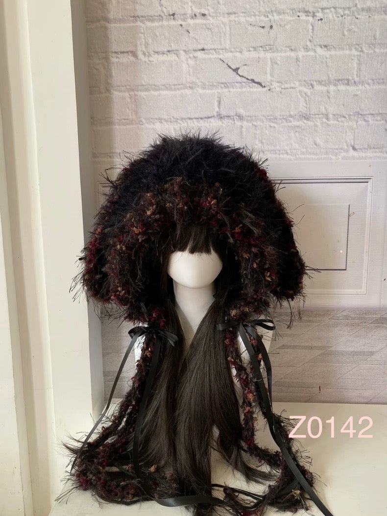 handmade crochet dark fairy goth bunny ear hood in black and deep red floral textured yarn with black satin ribbons and fur pompom ties. Whimsical headwear for cosplay, party and photoshoot styling