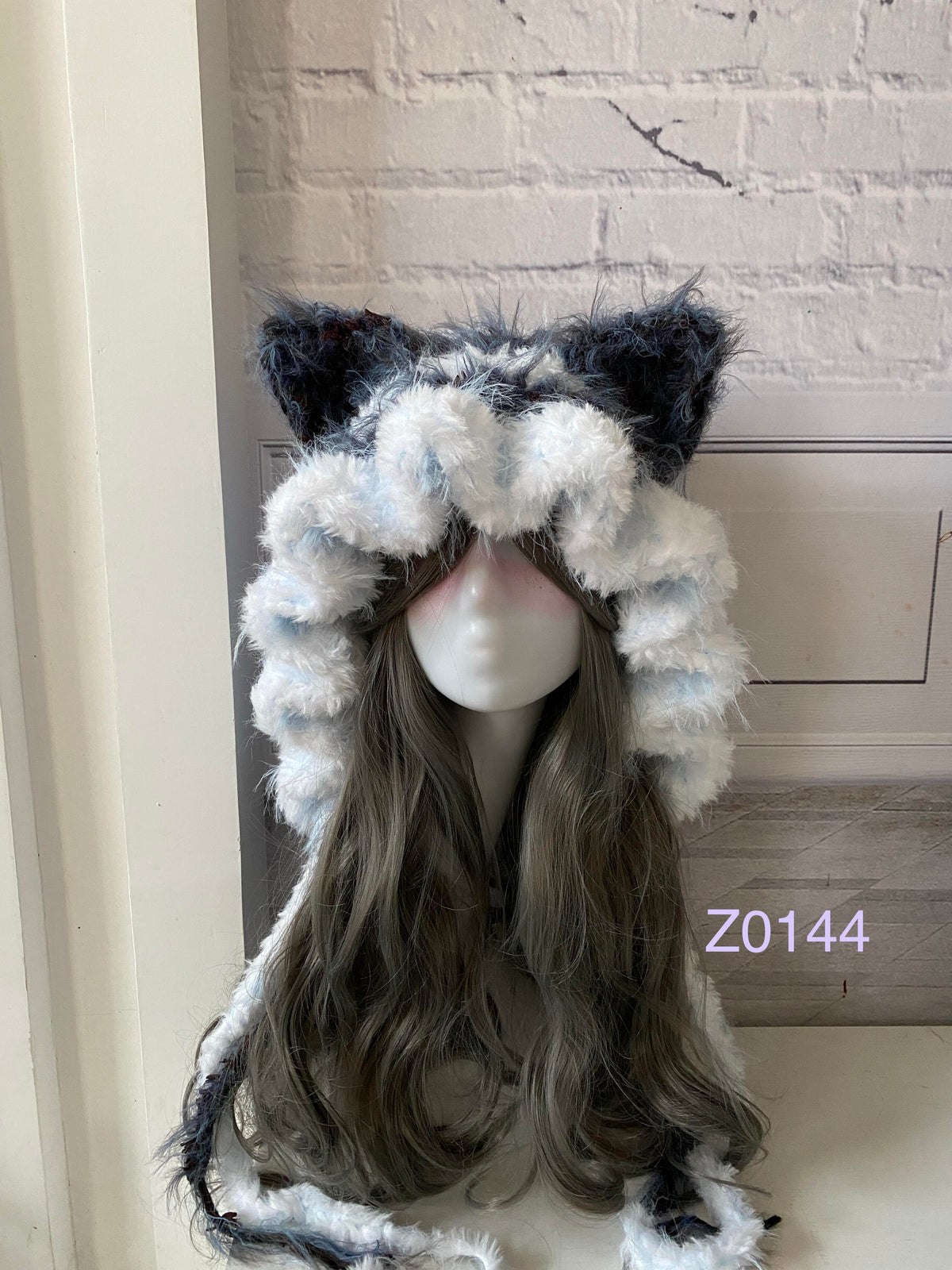 handmade crochet kawaii goth cat ear hood in dark blue and white fluffy contrast with pointed ears and long trailing ties. Cozy winter headwear for cosplay, photoshoot prop and gift idea