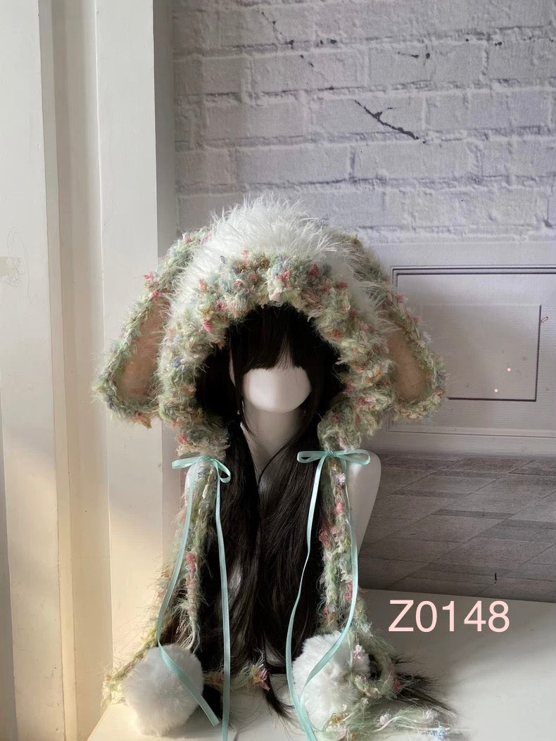 handmade crochet fairycore coquette bunny ear hood in soft mint green and pastel floral mixed yarn, mint satin ribbons and white pompom ties. Whimsical woodland headwear for cosplay, photoshoot prop and gift idea