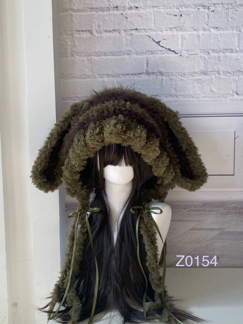handmade crochet goblincore woodland bunny ear hood in olive green fluffy contrast with long floppy ears, olive satin ribbons and long trailing ties. Cottagecore headwear for cosplay, music festival and photoshoot styling