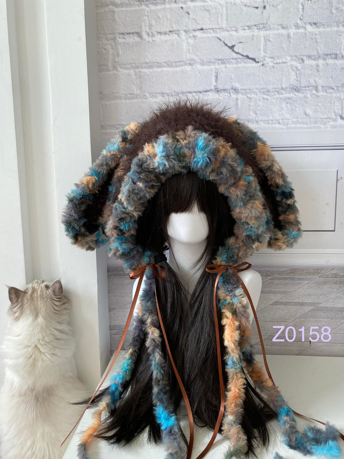 handmade crochet woodland goblincore bunny ear hood in dark brown mixed fluffy texture with long floppy ears, brown satin ribbons and long trailing ties. Cottagecore headwear for cosplay, music festival and photoshoot styling
