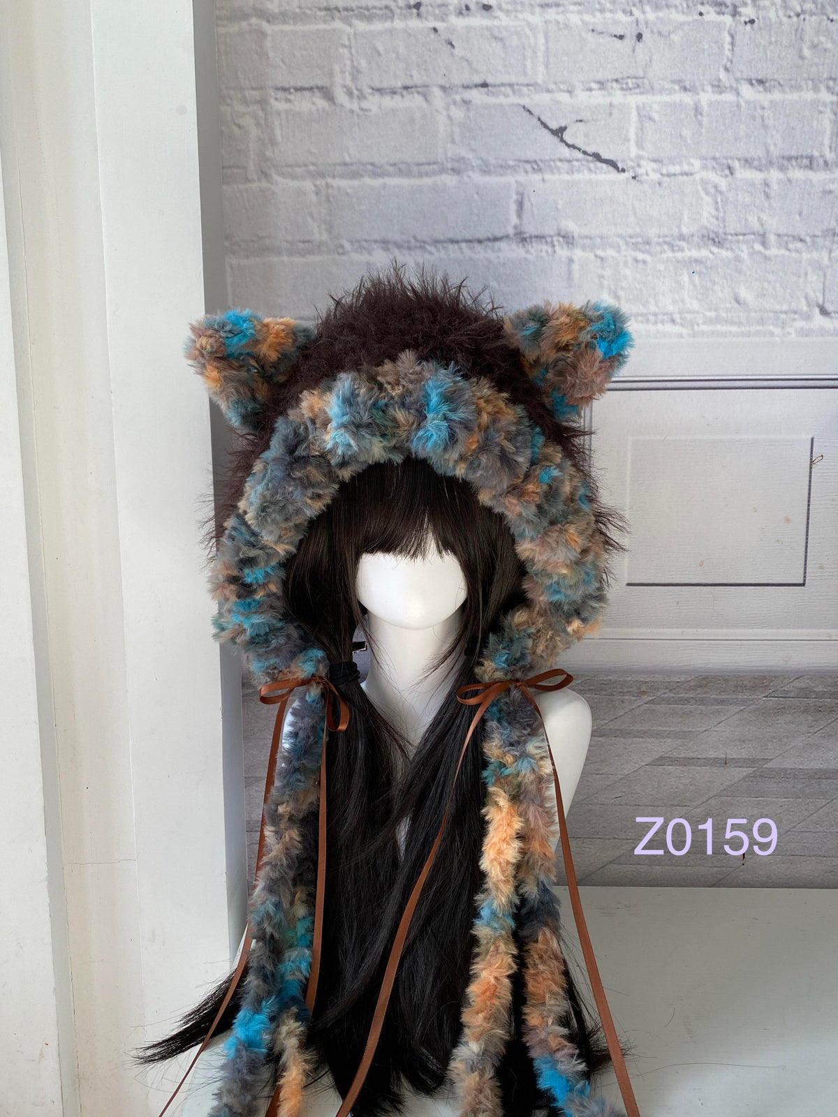 handmade crochet woodland goblincore cat ear hood in brown and blue mixed fluffy texture with pointed ears, brown satin ribbons and long trailing ties. Cottagecore headwear for cosplay, music festival and photoshoot styling