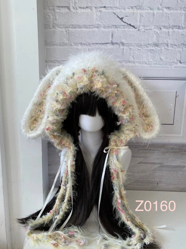 handmade crochet fairycore coquette bunny ear hood in cream fluffy texture with pastel speckled yarn details and white satin ribbons. Kawaii headwear for cosplay, photoshoot prop and winter festival styling