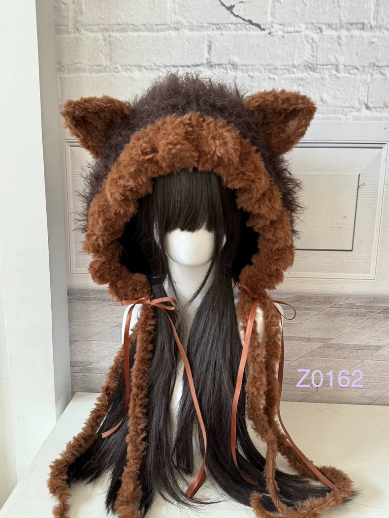 handmade crochet woodland cottagecore cat ear hood in dark brown and tan fluffy contrast with pointed ears, brown satin ribbons and long trailing ties. Mori girl style winter headwear for cosplay, festival and photoshoot styling