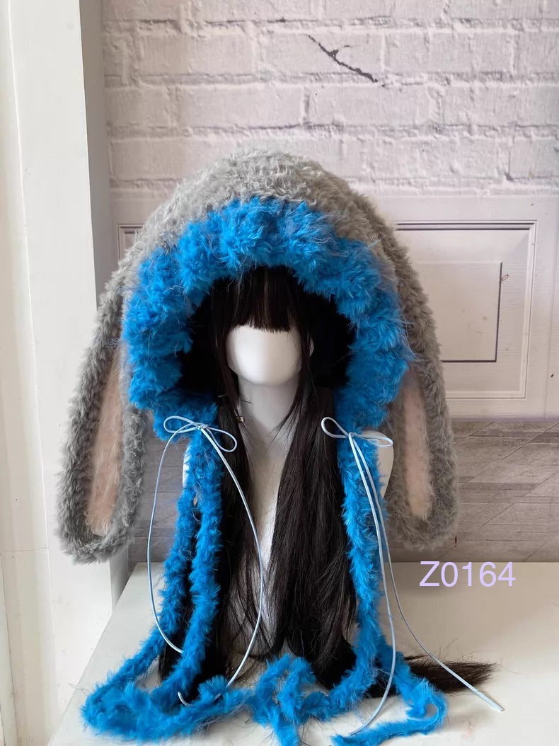 handmade crochet kawaii y2k fairy bunny ear hood in gray and bright blue fluffy contrast with long floppy ears, blue satin ribbon ties and soft plush texture. Cozy winter headwear for cosplay, rave party and photoshoot styling