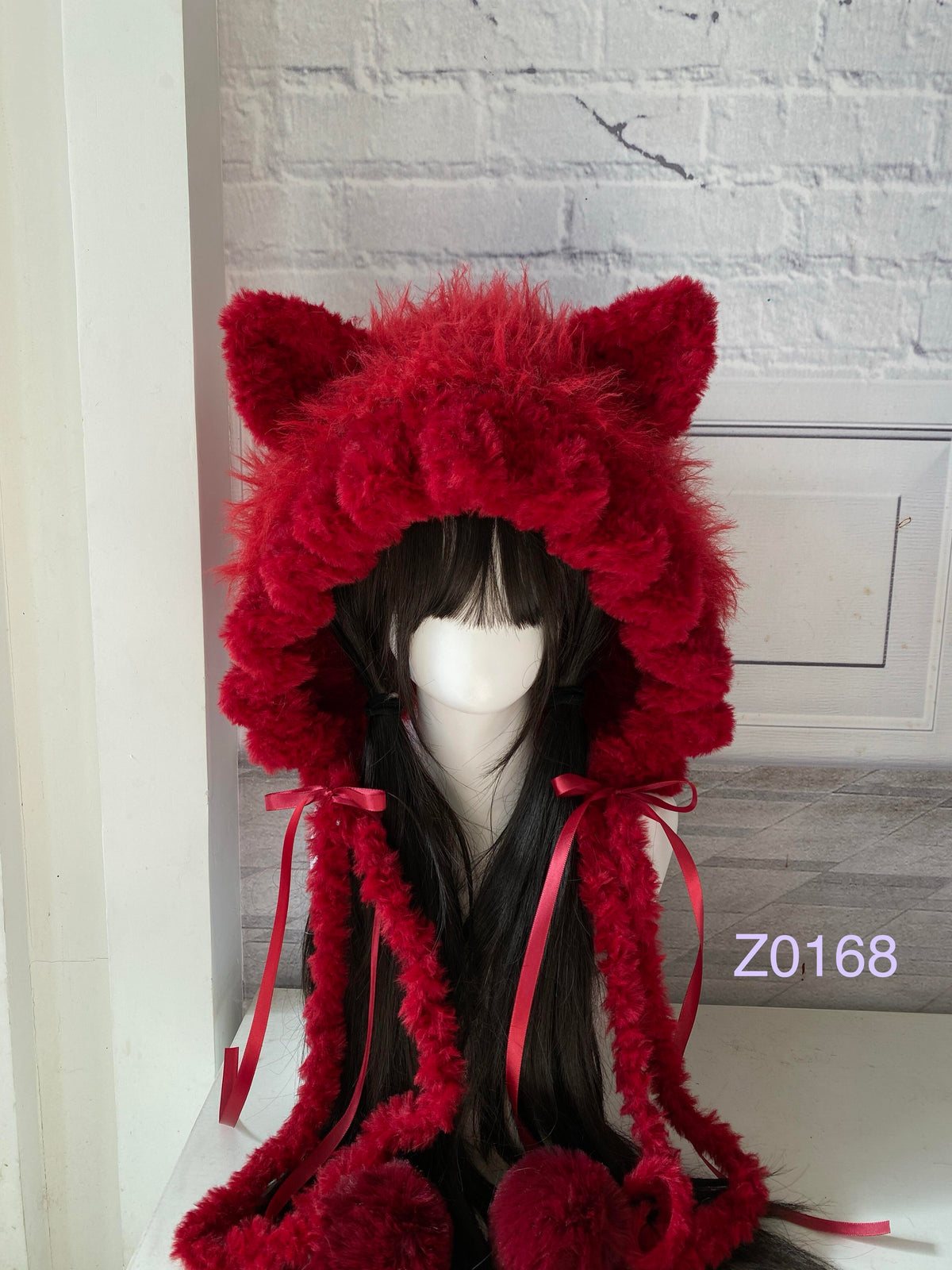 handmade crochet goth dark fairy cat ear hood in deep red fluffy texture with pointed ears, red satin ribbons and plush pompom ends. Whimsical cosplay headwear for Halloween, rave party and winter photoshoots