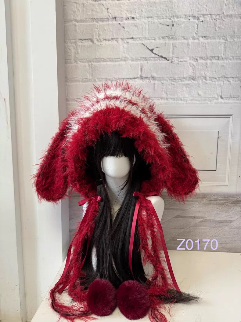 handmade crochet Christmas festive bunny ear hood in bold red and white fluffy contrast with long floppy ears, red satin ribbons and fur pompom ends. Holiday party headwear for cosplay, new year celebration and winter festival styling