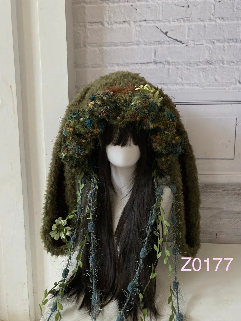 handmade crochet goblincore woodland jellyfish bunny ear hat in olive green moss and floral textured yarn with leafy vine ties and long trailing strands. Cottagecore headwear for cosplay, music festival and photoshoot styling