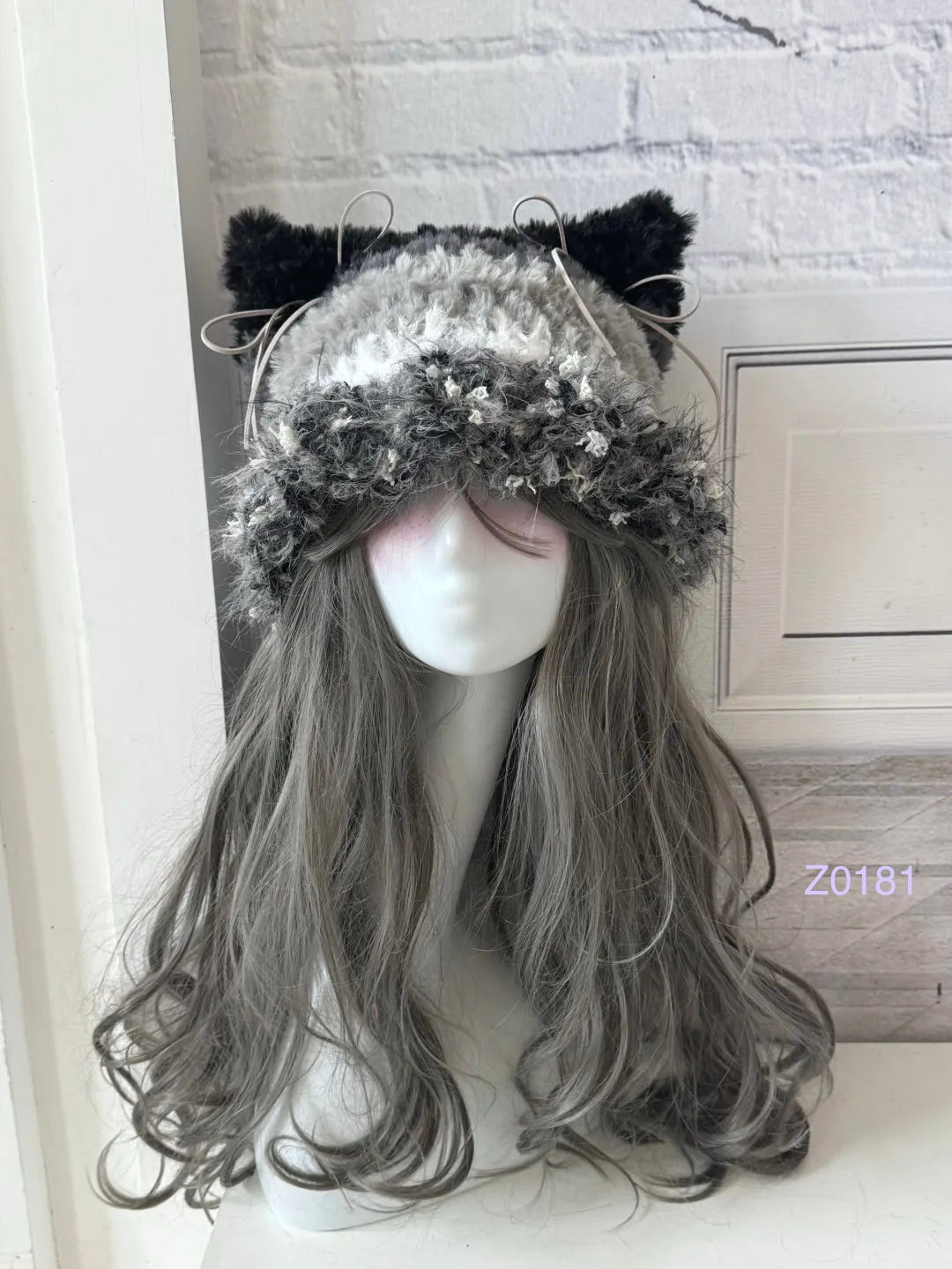 handmade crochet goth monochrome cat ear hat in black, white and gray fluffy contrast with pointed ears and long trailing ties. Dark fairy cosplay headwear for rave party and winter photoshoots