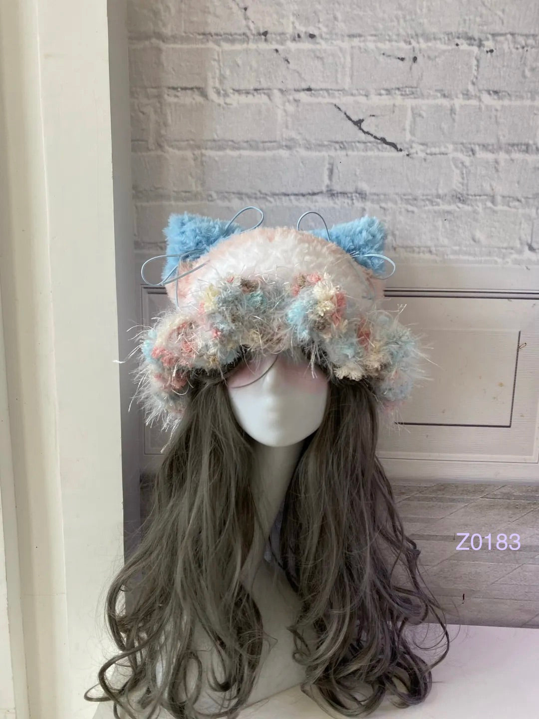 handmade crochet fairycore coquette cat ear hat in pink, blue and cream mixed fluffy texture with pointed ears and long trailing ties. Kawaii winter headwear for cosplay, photoshoot prop and gift idea