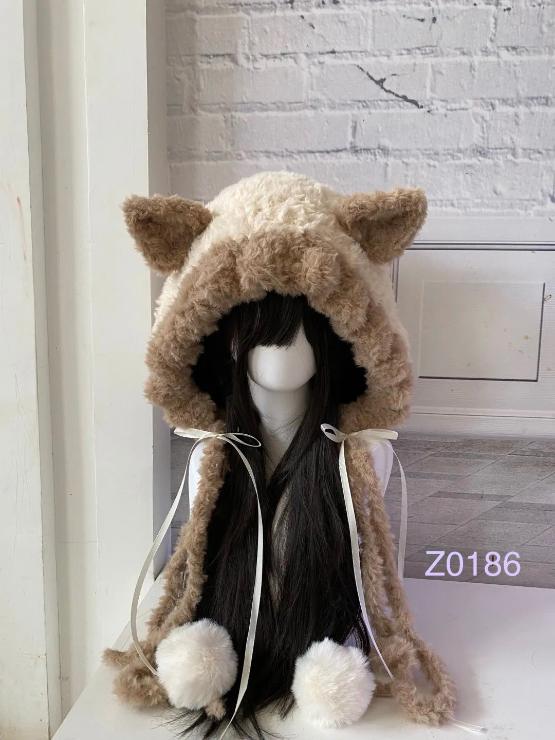 handmade crochet cottagecore coquette cat ear hood in cream and tan fluffy contrast with pointed ears, white satin ribbons and soft pompom ties. Cozy winter headwear for cosplay, photoshoot prop and gift idea