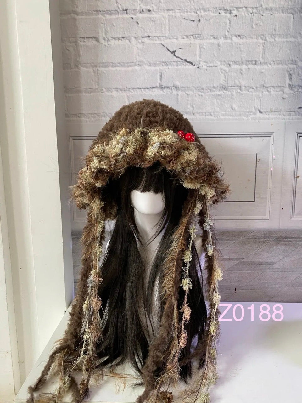 handmade crochet goblincore mushroomcore jellyfish hat in dark brown and moss textured yarn with tiny red mushroom accents and long trailing strands. Whimsical woodland headwear for cosplay, festival and photoshoot styling