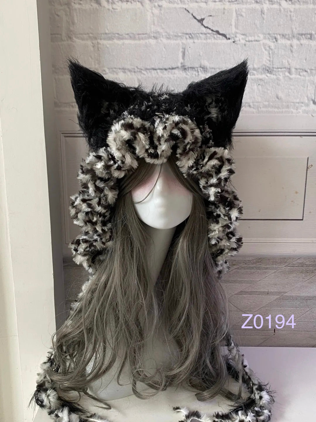 handmade crochet goth grunge fox ear hood in black and white leopard print fluffy texture, tall pointed ears and long trailing ties. Dark fairy headwear for cosplay, rave party and winter photoshoots