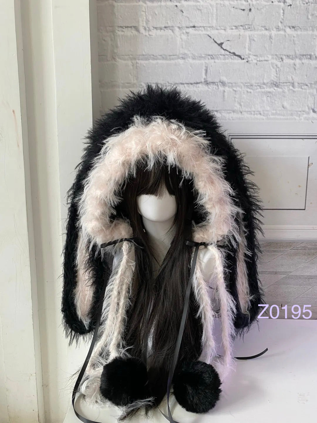 handmade crochet goth coquette bunny ear hood with dramatic black and pink fluffy texture, black satin ribbons and plush pompom ends. Kawaii cosplay hood for rave party and photoshoot prop