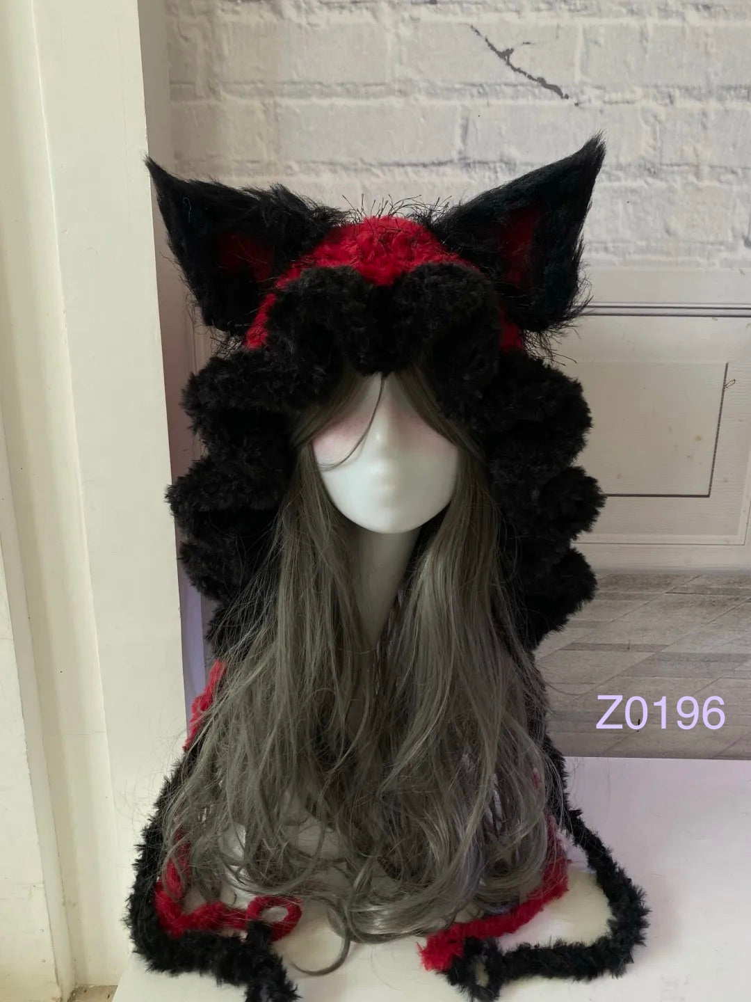 handmade crochet goth dark fairy fox ear hood with dramatic black and red fluffy contrast, tall pointed ears and long trailing ties. Whimsical cosplay headwear for rave party, Halloween and photoshoot styling
