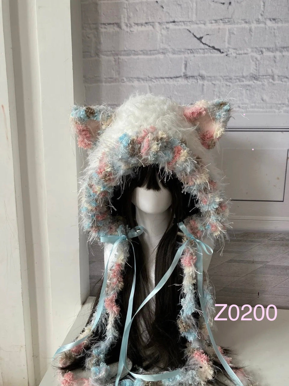 handmade crochet fairycore coquette cat ear hood in pastel pink, blue and cream floral textured yarn, light blue satin ribbons and fluffy trim. Kawaii headwear for cosplay, photoshoot prop and gift idea