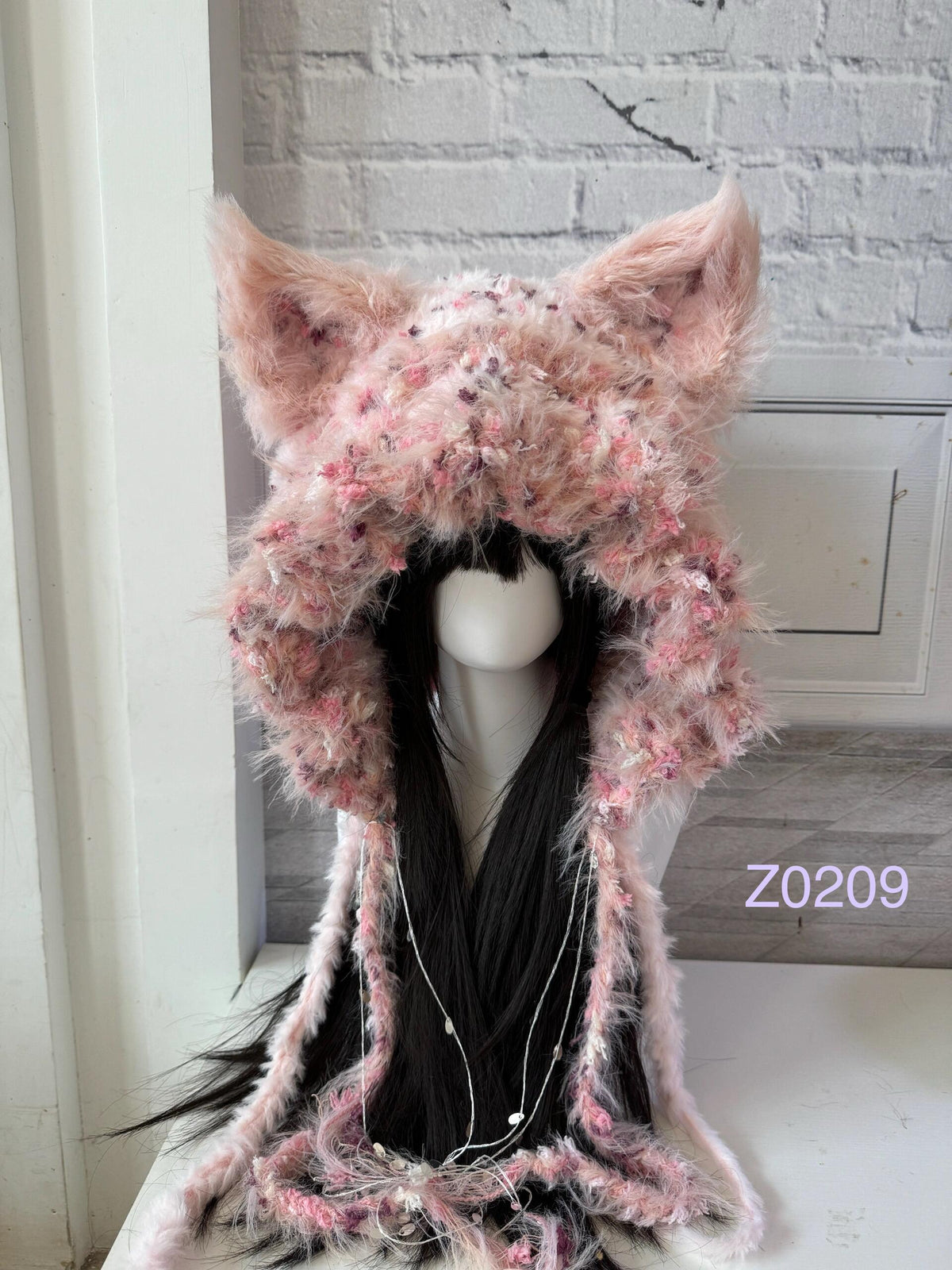handmade crochet coquette fairycore wolf ear hood in pink floral fluffy texture with tall pointed ears and long trailing ties. Whimsical winter headwear for cosplay, photoshoot prop and romantic gift giving