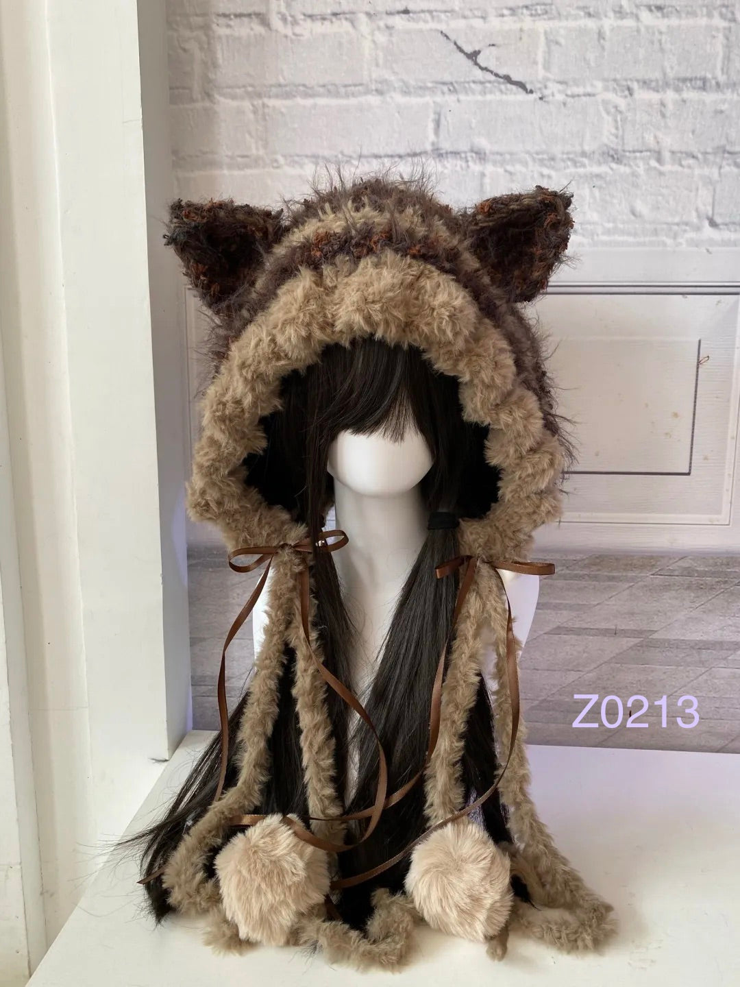 handmade crochet woodland cottagecore cat ear hood in warm brown and tan fluffy texture with brown satin ribbons and fur pompom ends. Mori girl style headwear for cosplay, winter festival and photoshoots