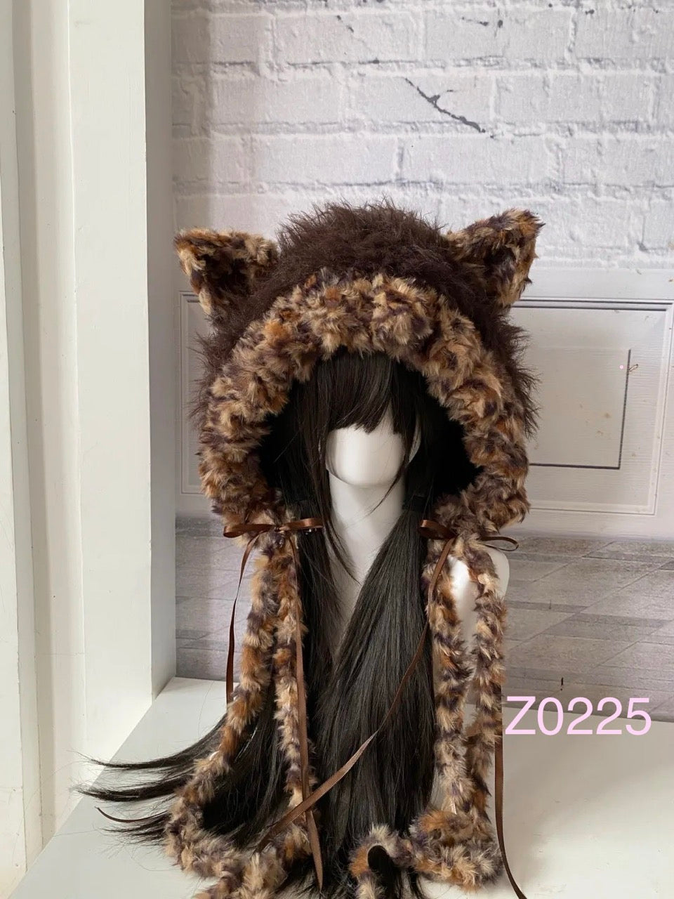 handmade crochet grunge dark fairy cat ear hood in leopard print fluffy texture with brown satin ribbons and long trailing ties. Whimsical cosplay headwear for rave party and winter photoshoots