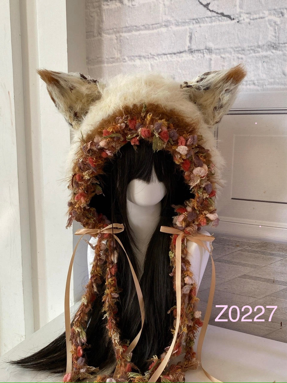 handmade crochet cottagecore fairycore fox ear hood in cream and floral textured yarn with pointed ears and satin ribbon ties. Whimsical woodland headwear for cosplay, photoshoot prop and gift idea