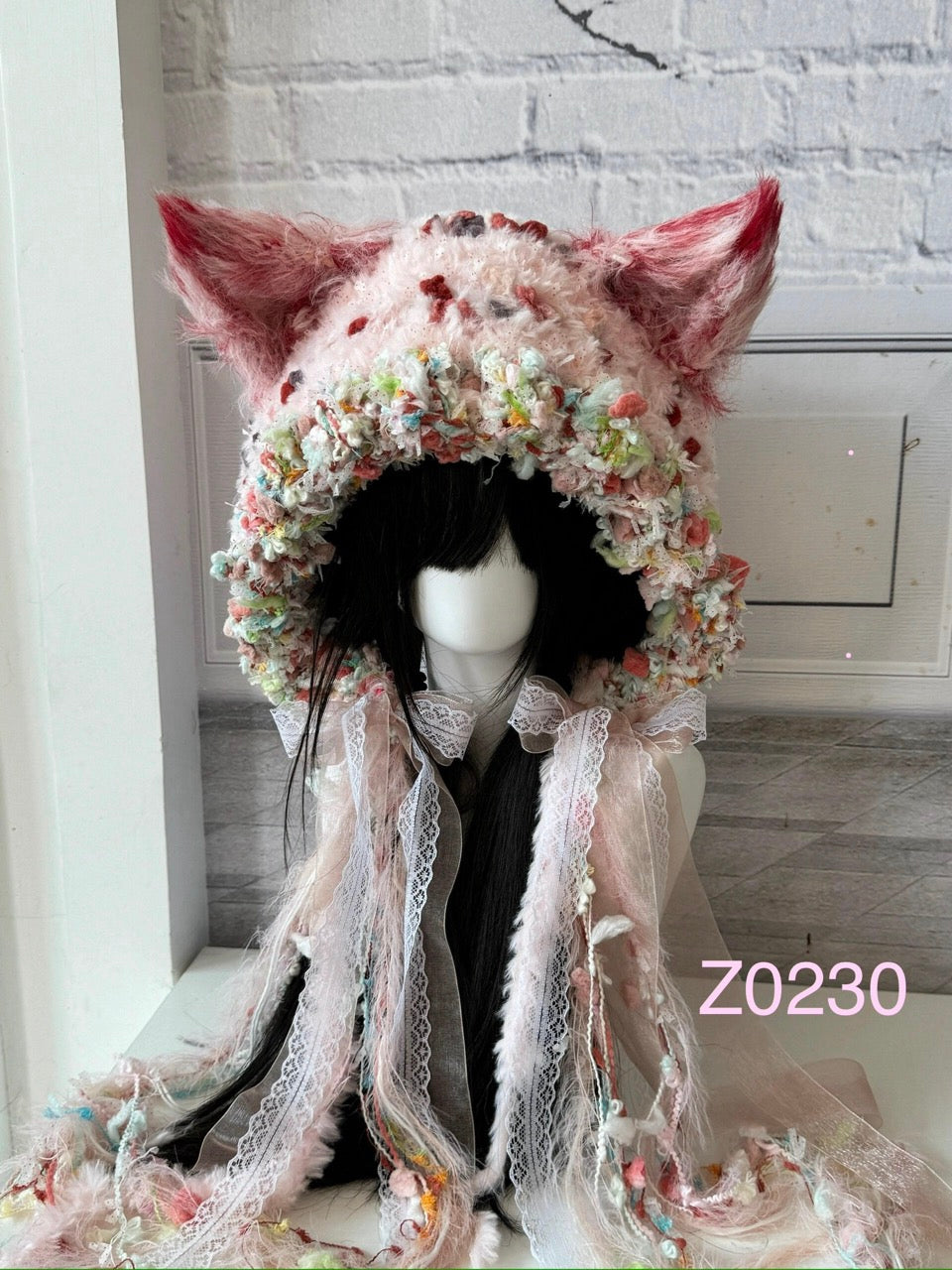 handmade crochet fairycore coquette fox ear hood in soft pink floral textured yarn with delicate lace ribbons and pointed ears. Dollette style headwear for cosplay, photoshoot prop and romantic festival styling