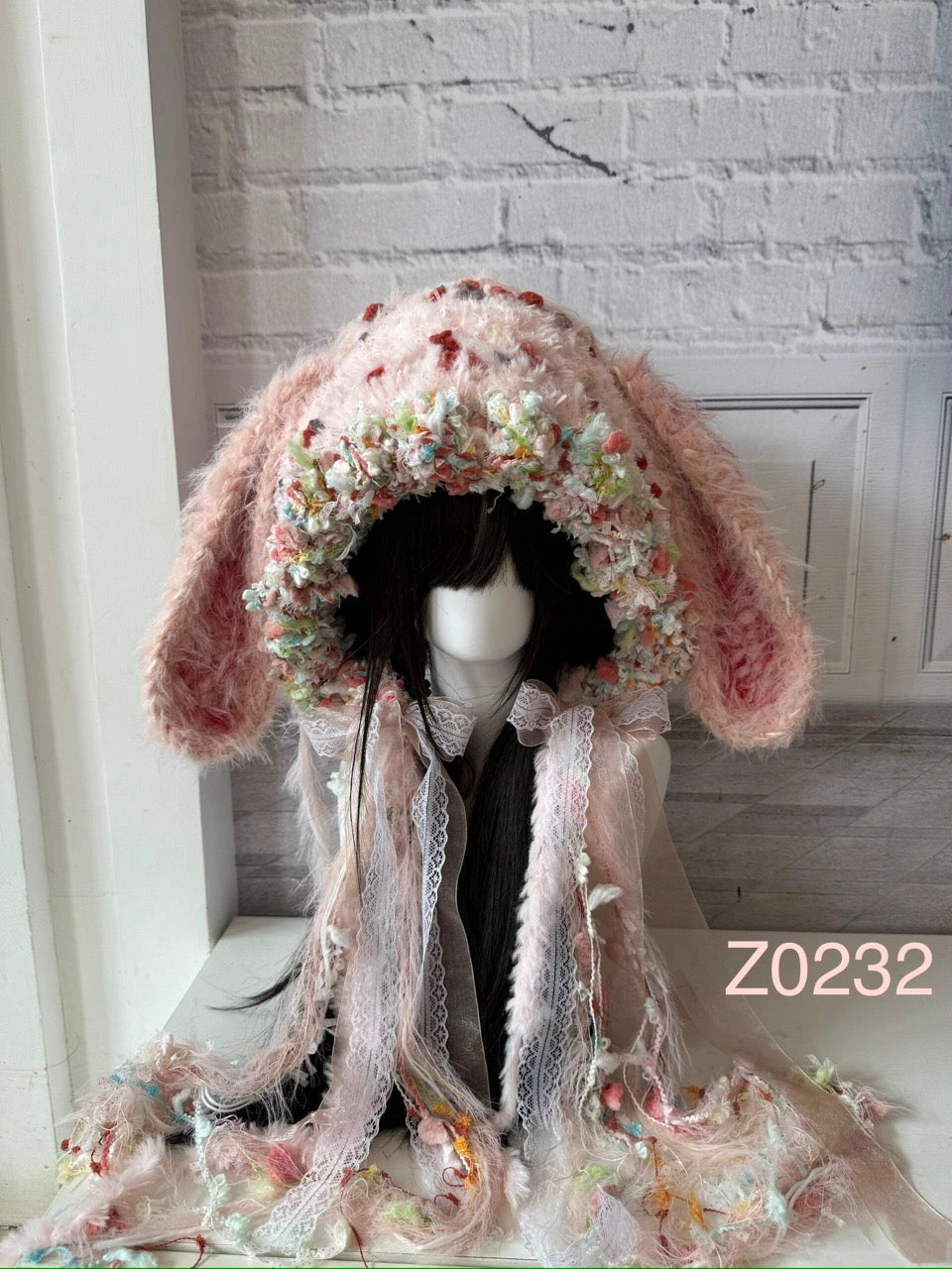 handmade crochet coquette fairycore bunny ear hood in soft pink floral textured yarn with delicate lace ribbons and sheer tulle details. Dollette style headwear for cosplay, party and romantic photoshoots