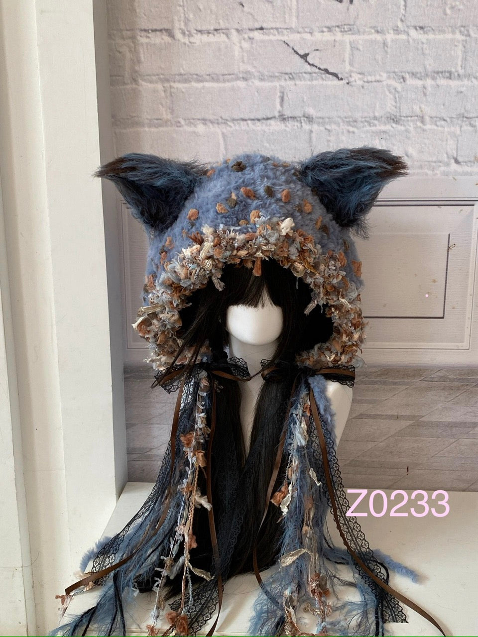 handmade crochet goth cottagecore fox ear hood in blue gray floral textured yarn with black lace ribbons and pointed ears. Dark fairy headwear for cosplay, photoshoot styling and winter festival wear