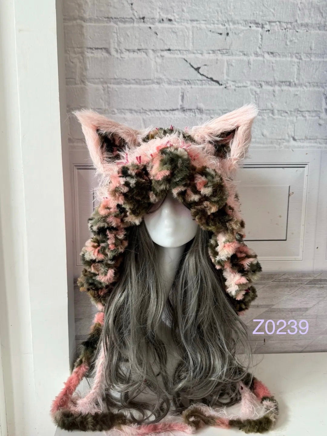 handmade crochet coquette grunge fox ear hood in pink leopard print fluffy texture with tall pointed ears and long trailing ties. Kawaii cosplay headwear for rave party and photoshoot styling