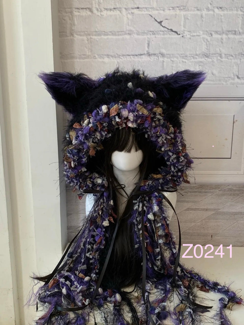 handmade crochet goth dark fairy fox ear hood with bold black and purple floral textured contrast, tall pointed ears and long trailing ribbons. Whimsical cosplay headwear for rave party, Halloween and photoshoot styling