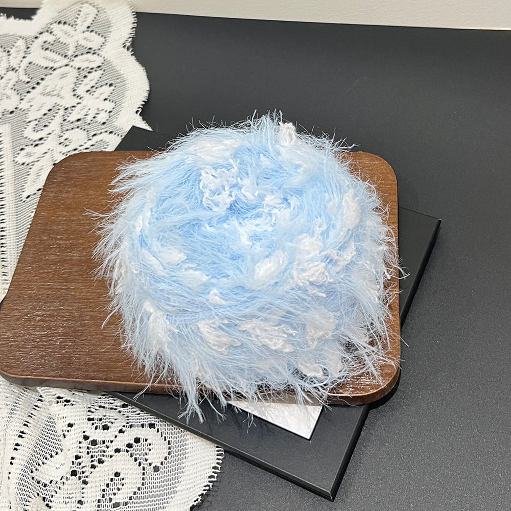 Close up pale blue white airy cloud fiber, long pile airy textured mixed yarn