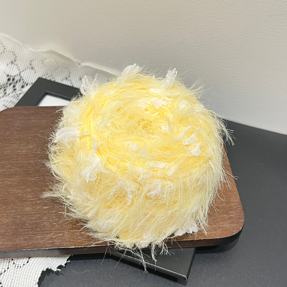 Close up warm lemon yellow white soft petal fiber, airy long pile mixed yarn texture