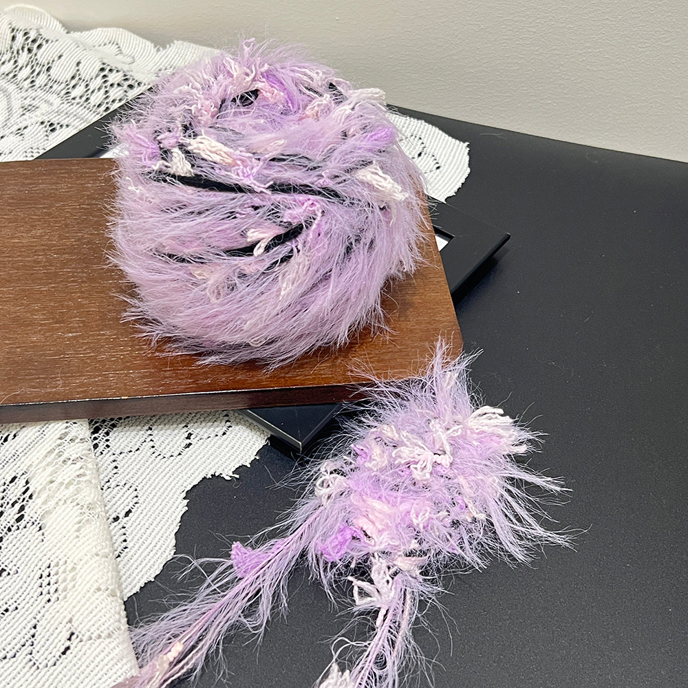 Dark pastel lavender cake yarn styled with white lace, unique gothic textured art yarn for DIY
