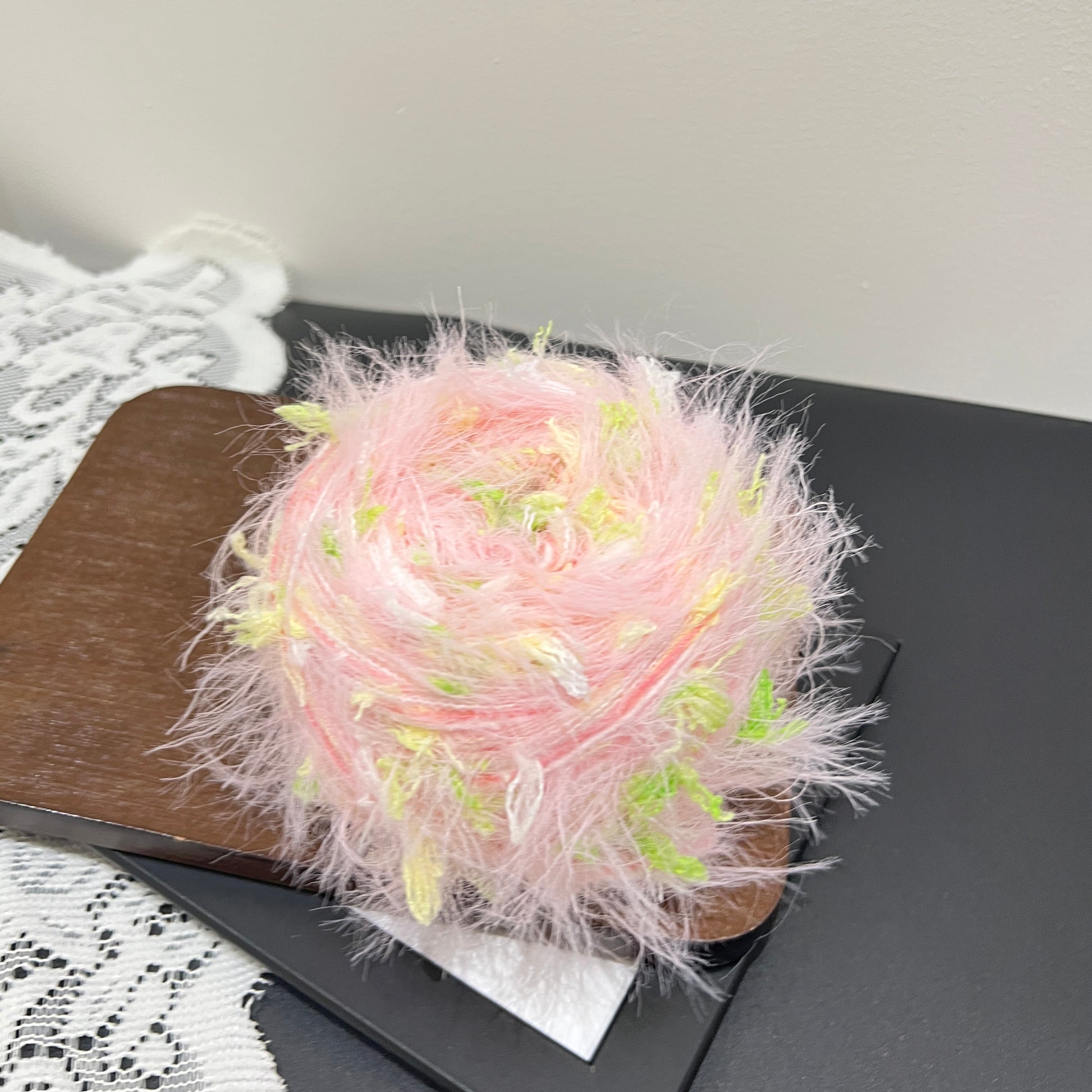 Full spherical front shot pastel pink lime multi-tone floral hand-blended cake yarn